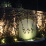 Uplighting on a stone wall and fountain