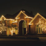 Holiday lights outlining a brick home